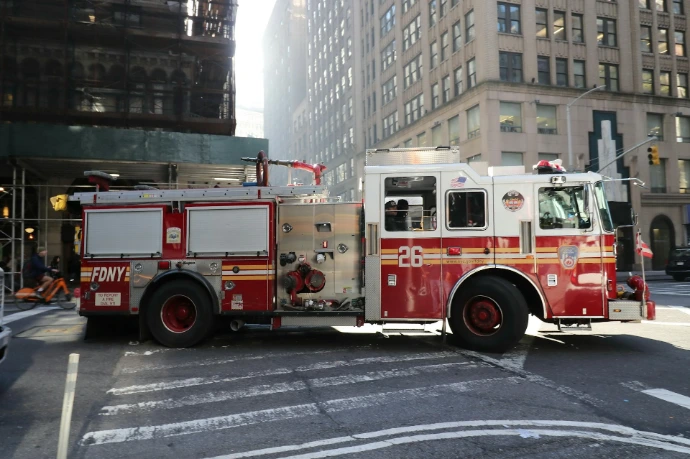 A red and white fire truck parked on city street